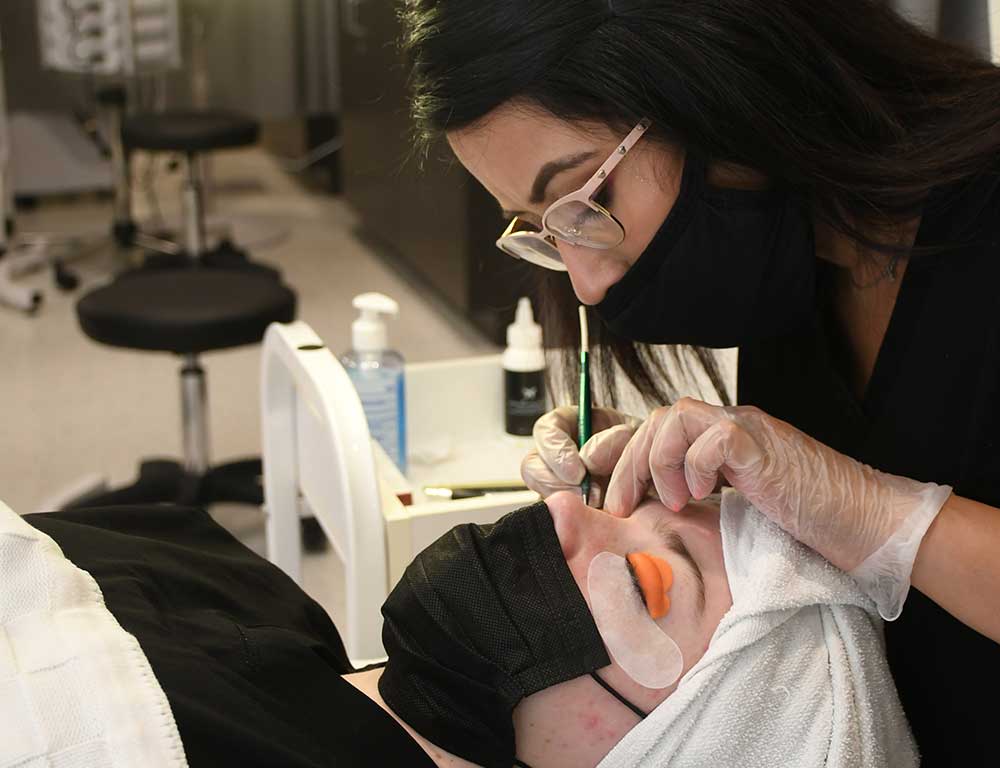 Cosmetology student performing a facial