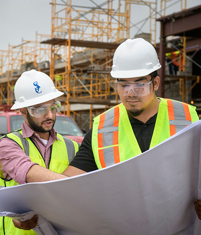 Construction workers reading blueprint
