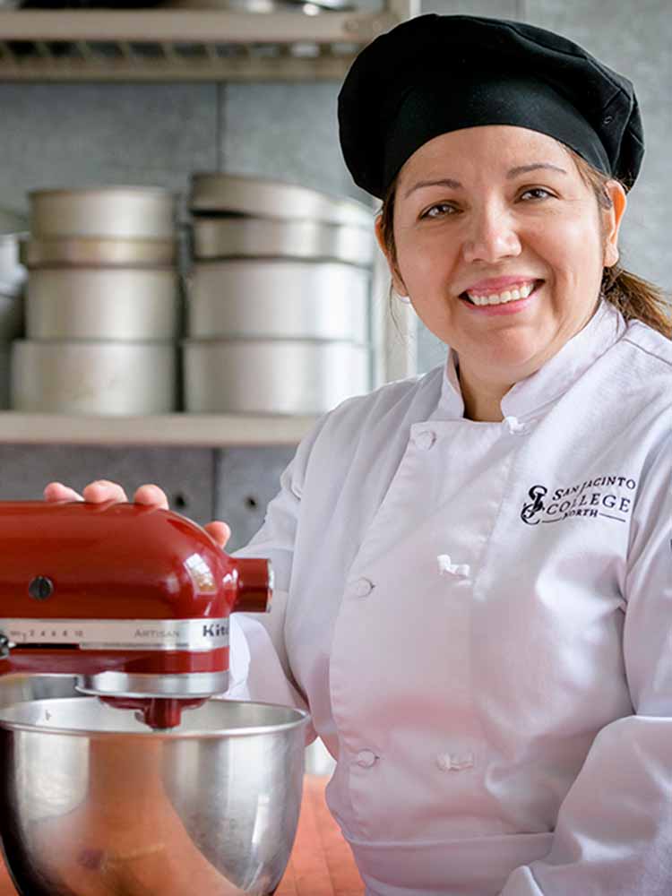 culinary student posing with kitchen aid