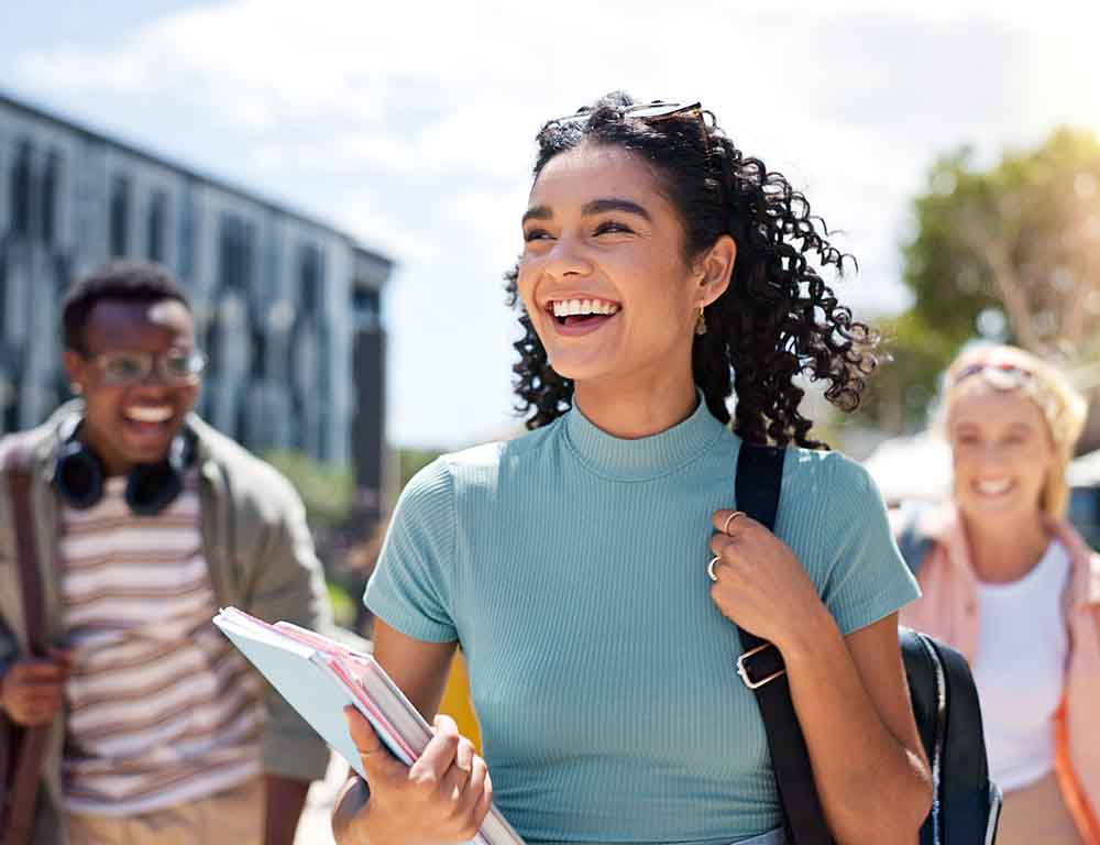 student smiling with friends while walking