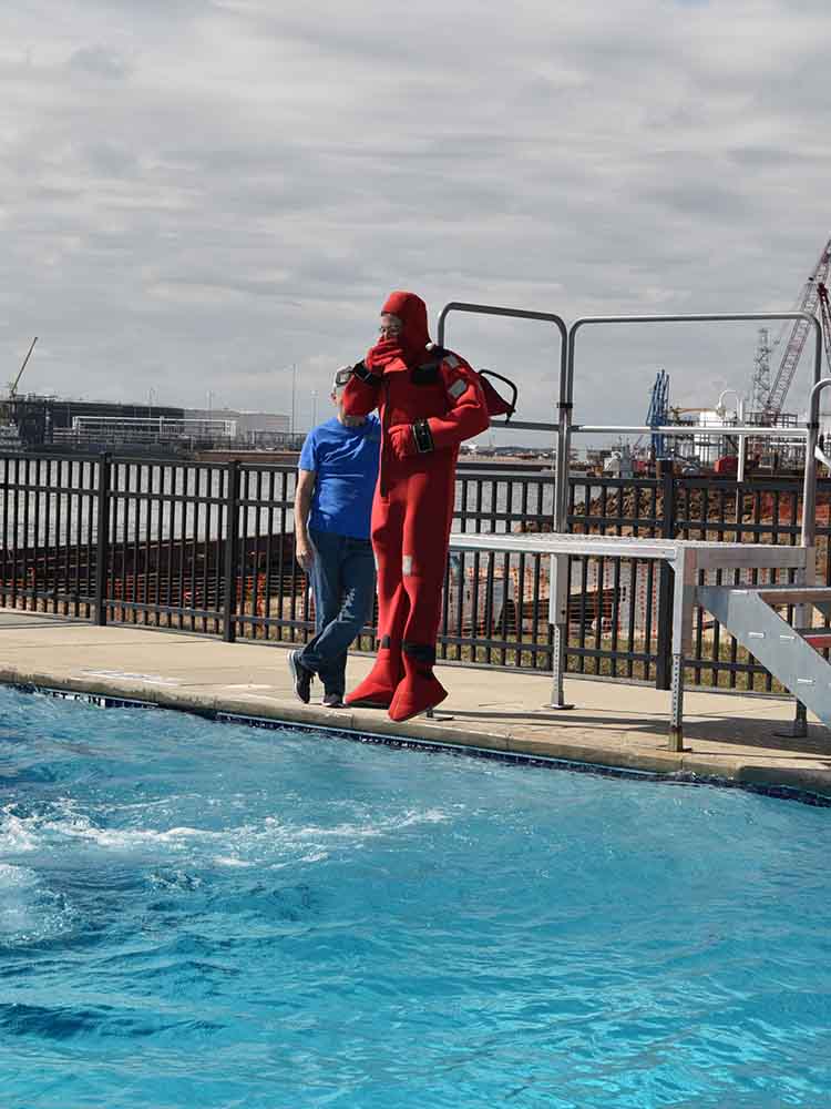 Diver jumping in pool.